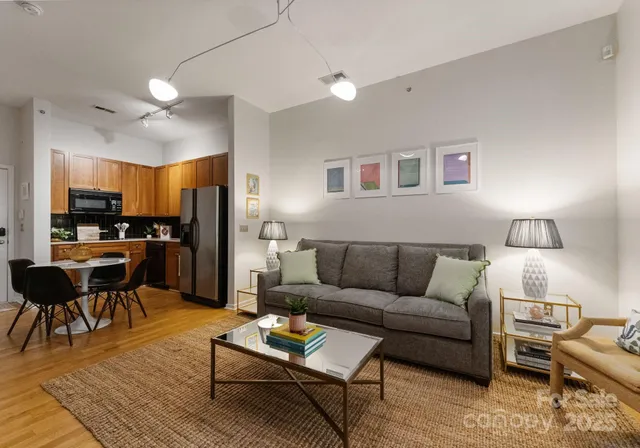 a living room with furniture and kitchen view