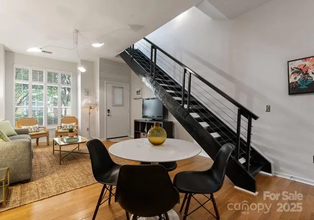 a view of a dining room with furniture and a potted plant