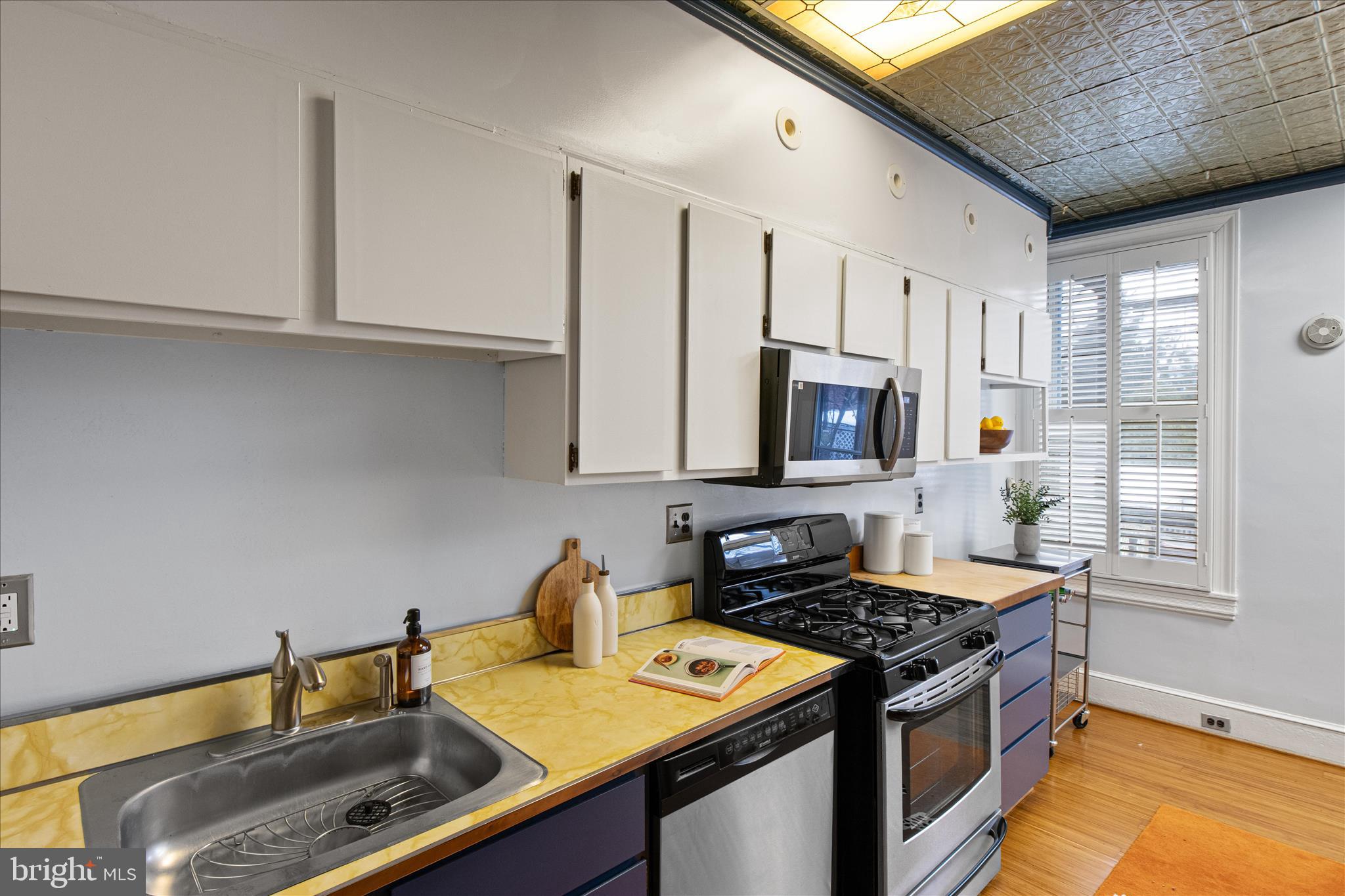 140 11th Street Northeast Washington, DC 20002 - Photo 11 of 45 a kitchen with stainless steel appliances granite countertop a sink stove and cabinets