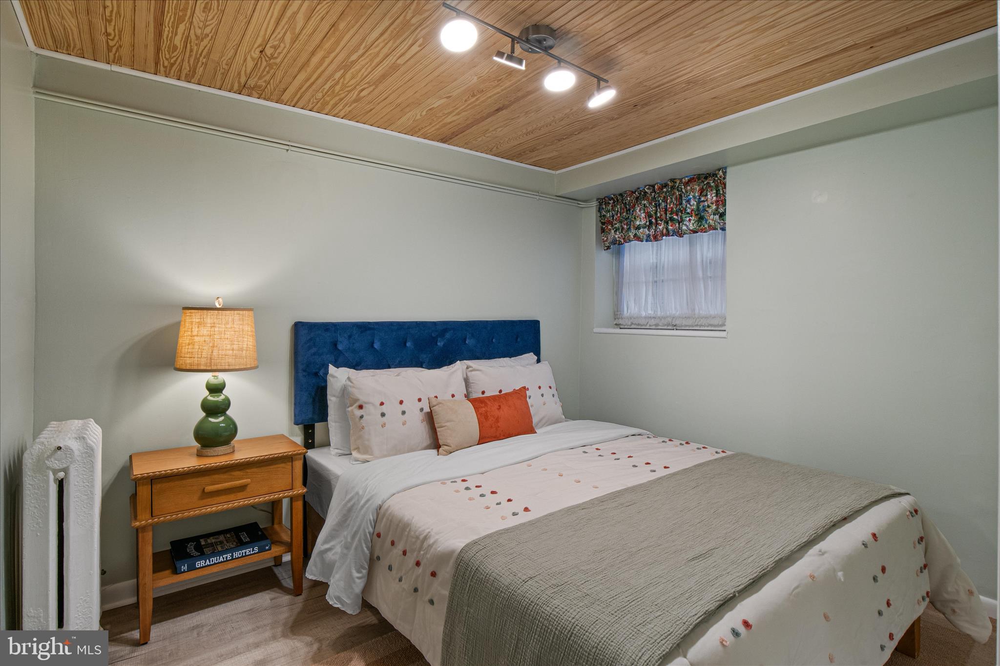 140 11th Street Northeast Washington, DC 20002 - Photo 35 of 45 a bedroom with a bed and a lamp on dresser