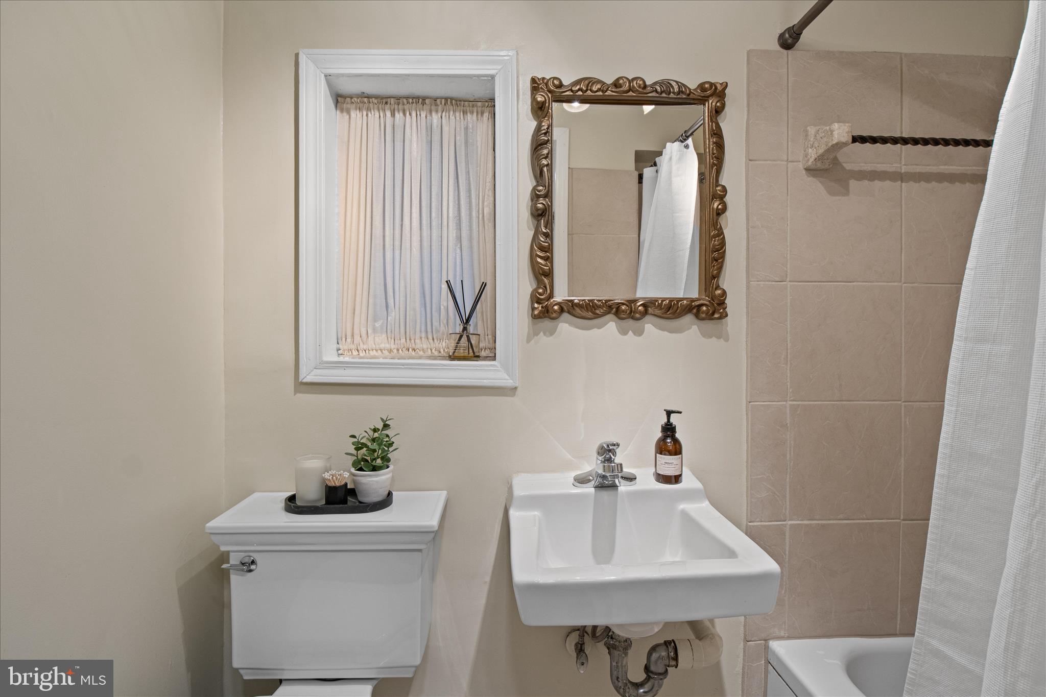 140 11th Street Northeast Washington, DC 20002 - Photo 36 of 45 a bathroom with a sink a toilet and a mirror