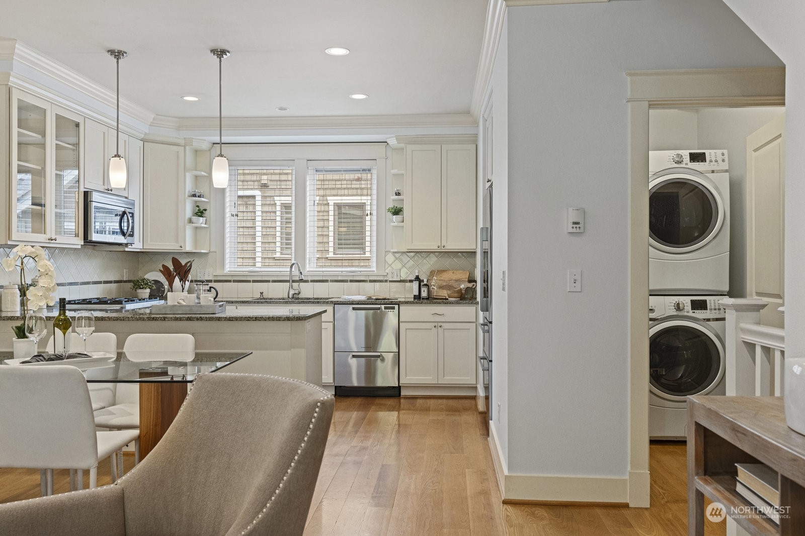 16 West Etruria Street Seattle, WA 98119 - Photo 13 of 40 a view of a kitchen with a sink dishwasher a washer and dryer with wooden floor