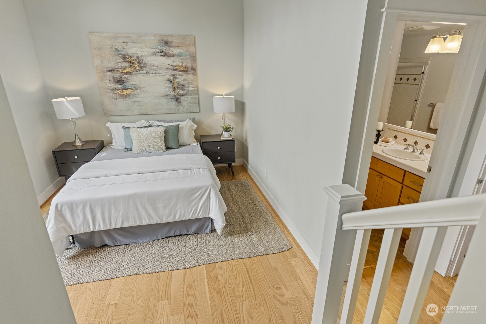 16 West Etruria Street Seattle, WA 98119 - Photo 19 of 40 a bedroom with a bed and a wooden floor
