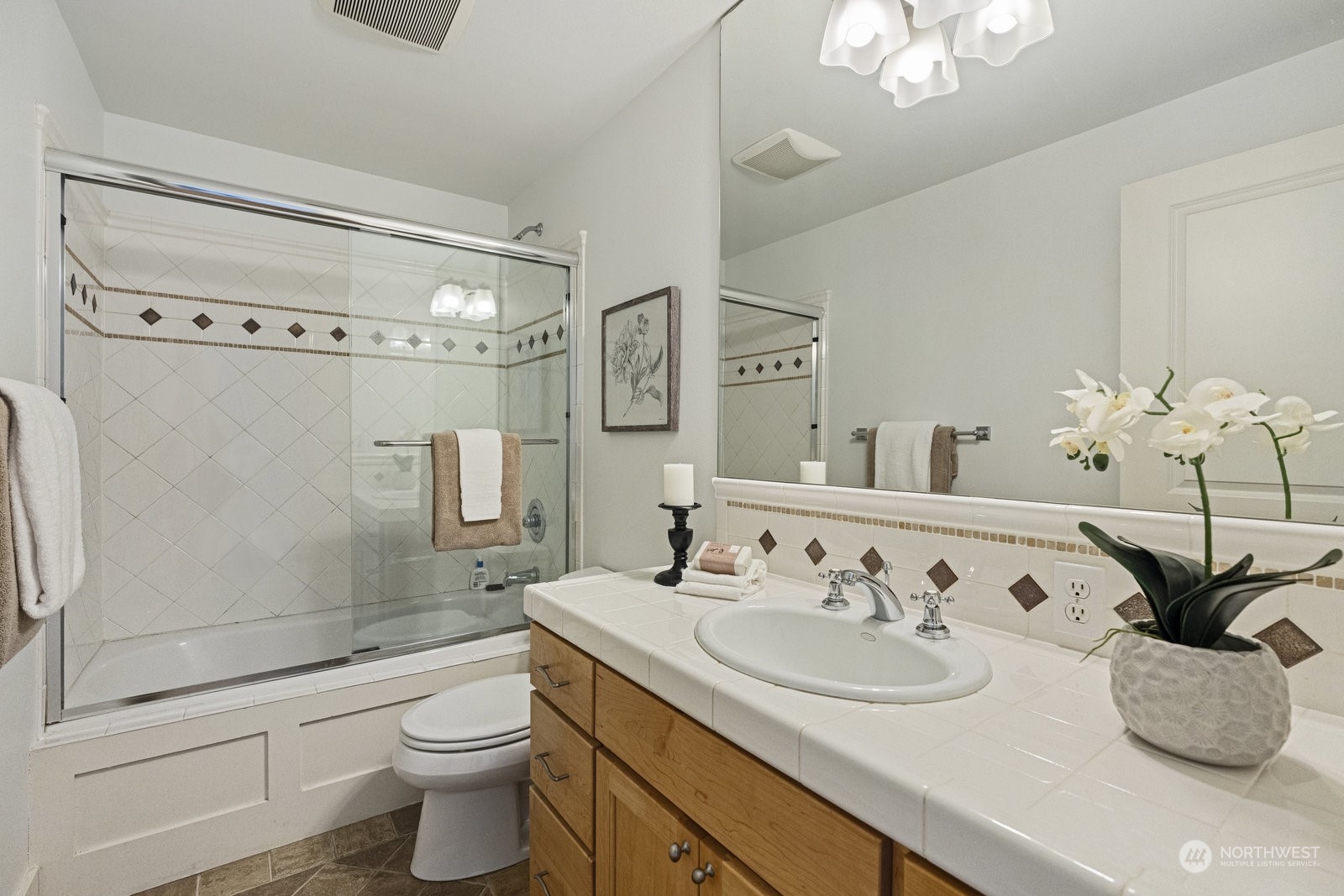 16 West Etruria Street Seattle, WA 98119 - Photo 20 of 40 a bathroom with a granite countertop sink a toilet and shower