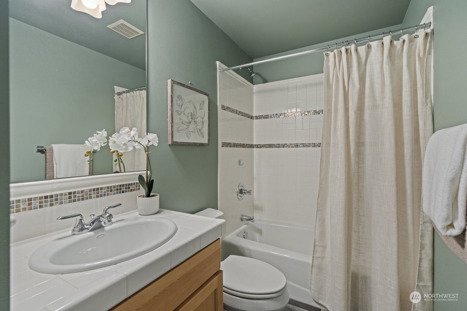 16 West Etruria Street Seattle, WA 98119 - Photo 26 of 40 a bathroom with a sink toilet a mirror and shower