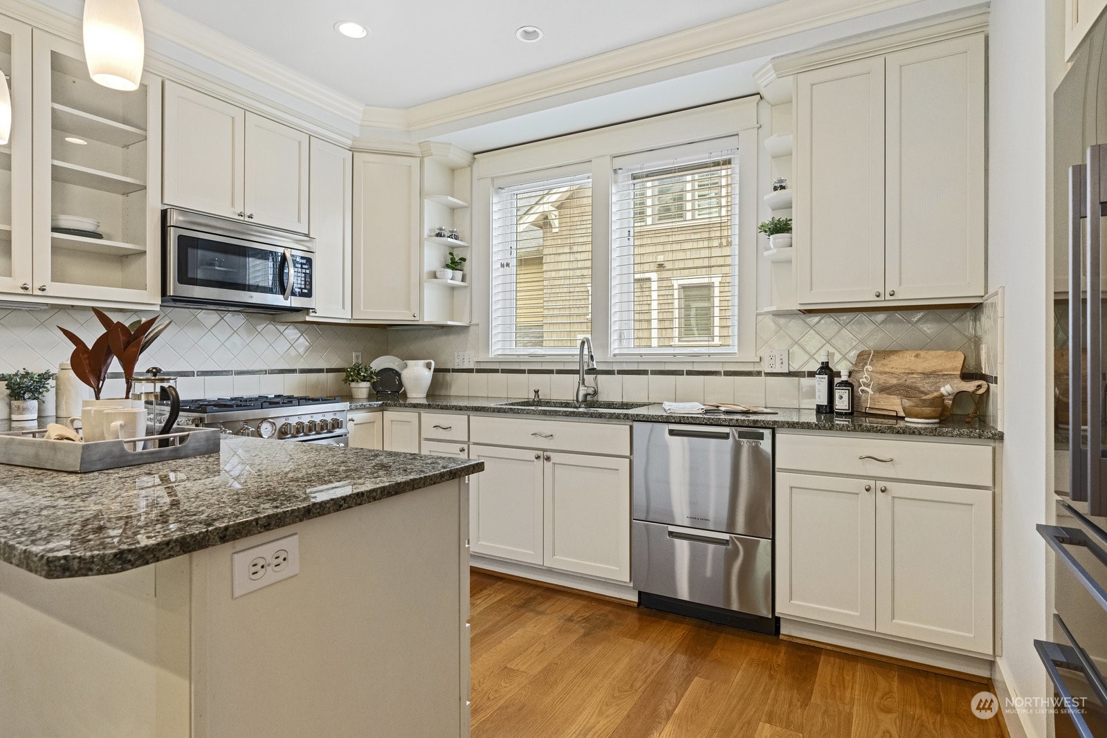 16 West Etruria Street Seattle, WA 98119 - Photo 9 of 40 a kitchen with stainless steel appliances granite countertop a sink stove and microwave