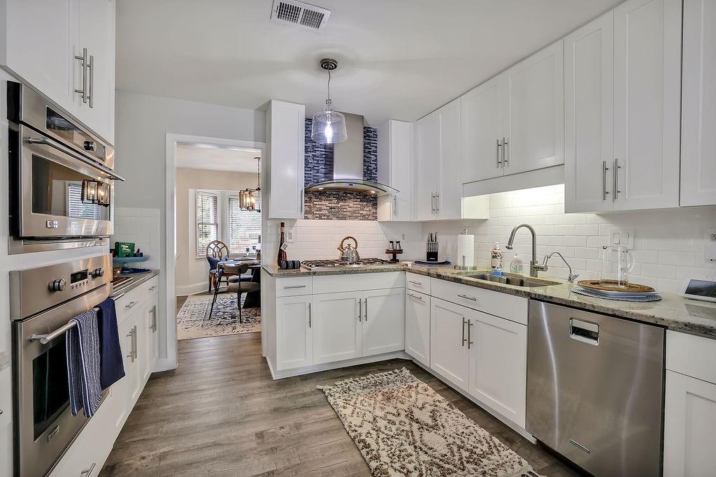 5455 Shiver Summit Northeast Atlanta, GA 30342 - Photo 12 of 14 a kitchen with stainless steel appliances granite countertop white cabinets a sink dishwasher a stove and a refrigerator