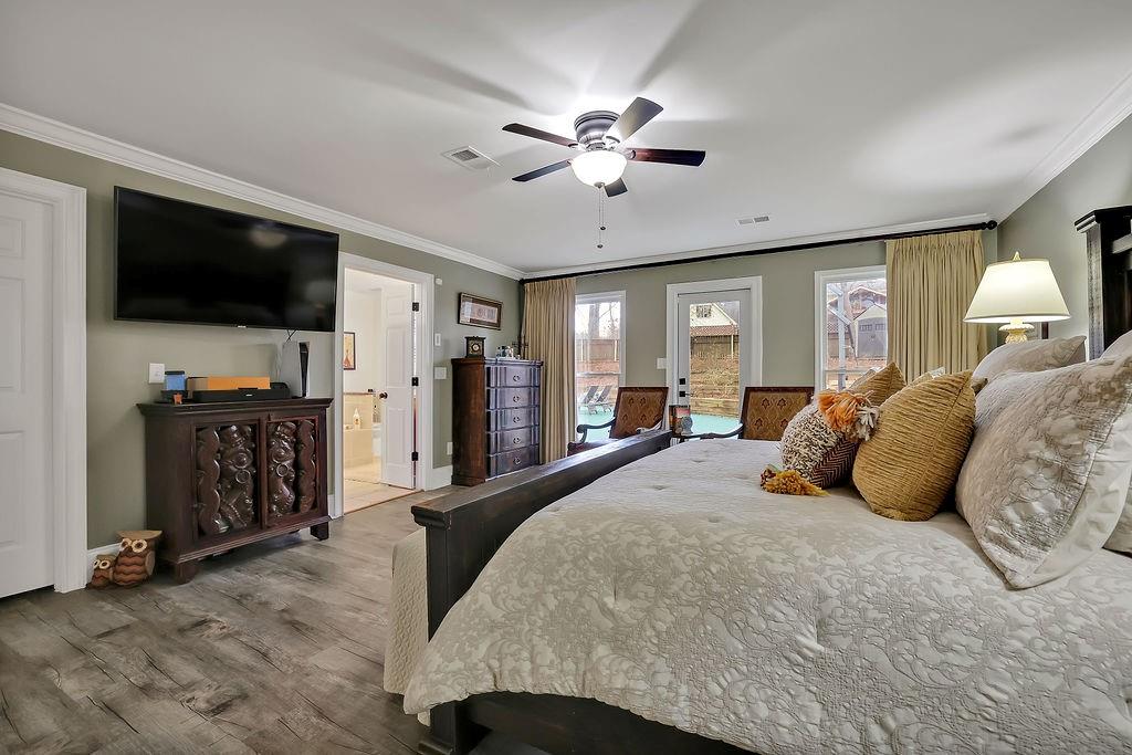 5455 Shiver Summit Northeast Atlanta, GA 30342 - Photo 13 of 14 a spacious bedroom with a bed and a flat screen tv