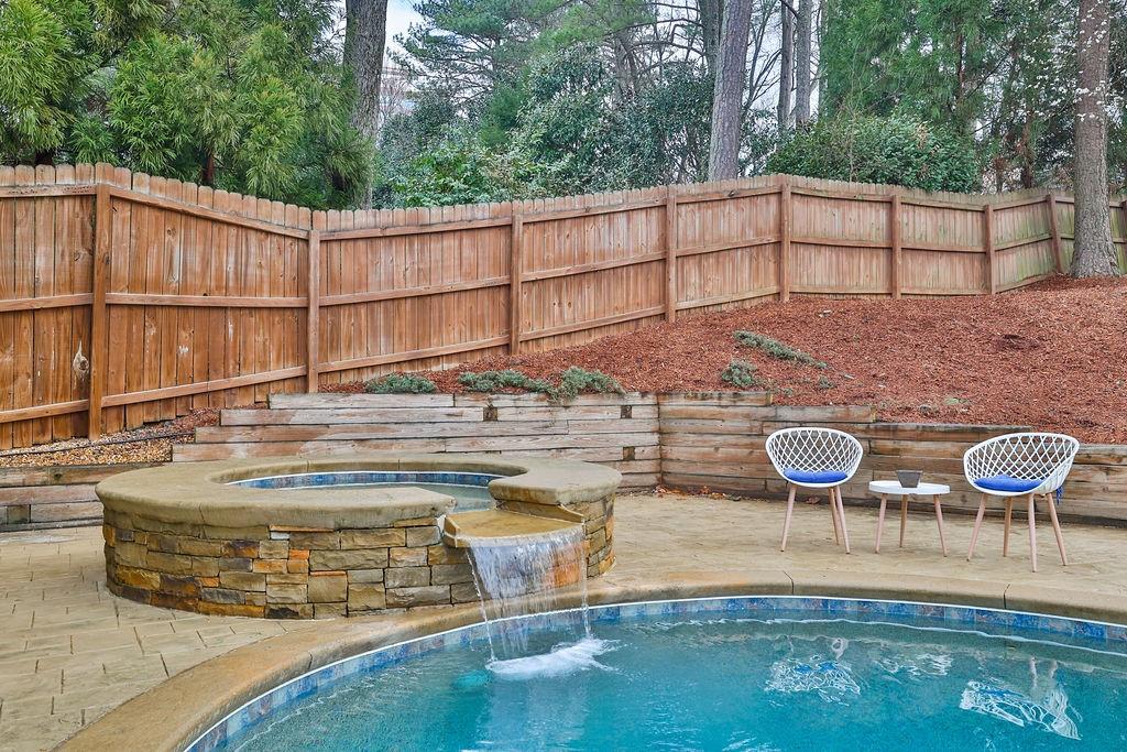 5455 Shiver Summit Northeast Atlanta, GA 30342 - Photo 6 of 14 a view of a patio with table and chairs with wooden fence and plants