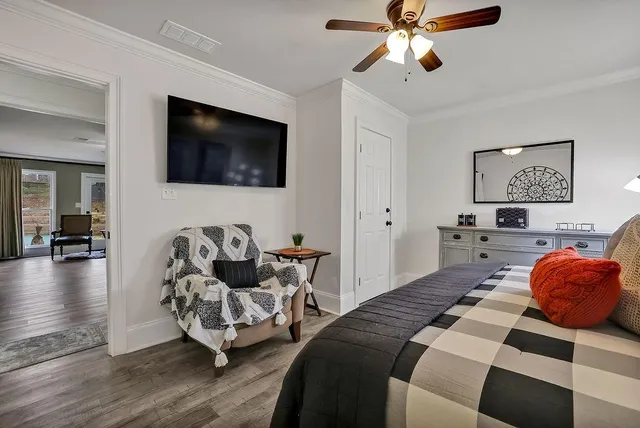 a bedroom with furniture and a flat screen tv