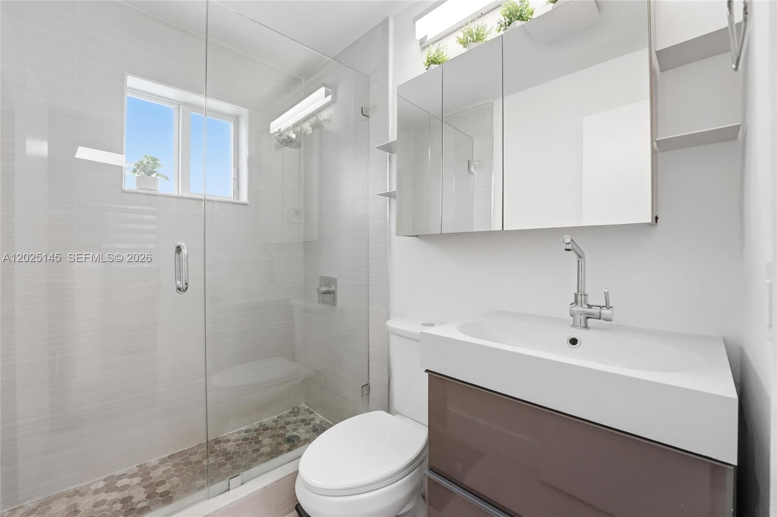 3101 Southwest 25th Terrace Miami, FL 33133 - Photo 15 of 31 a bathroom with a sink a toilet and shower