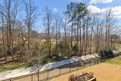 a swimming pool with trees in front of it