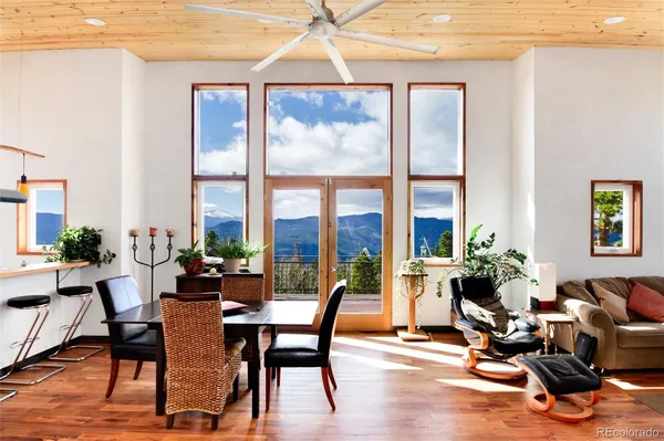 a living room with furniture and floor to ceiling windows