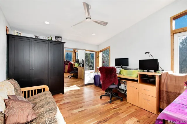a view of a livingroom with workspace and a window