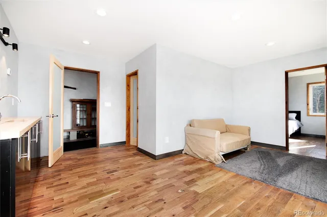 a living room with furniture and a walk in closet