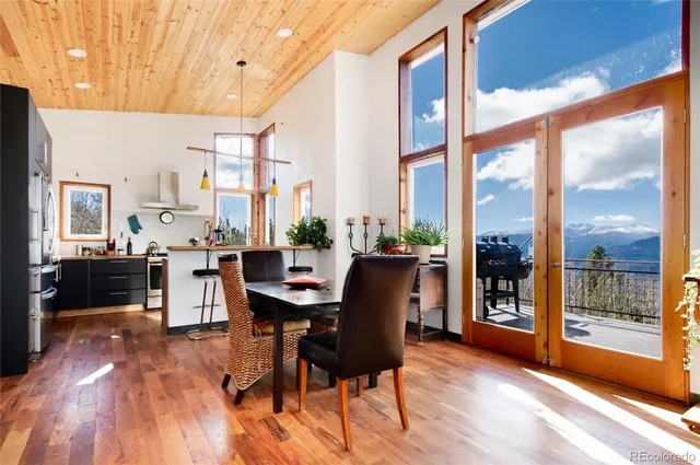 a view of a dining room with furniture window and wooden floor