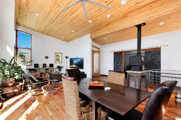 a living room with furniture a flat screen tv and kitchen view