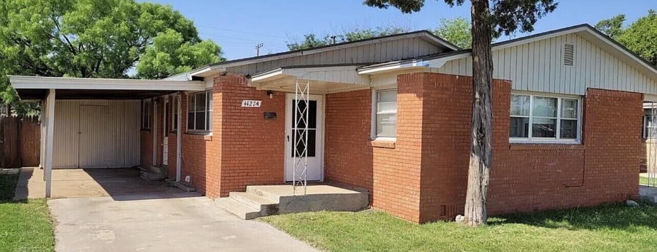 4427 31st Street, Unit A Lubbock, TX 79410 - Photo 2 of 9 a front view of a house with garden