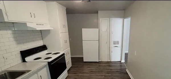 a kitchen with a stove and a refrigerator