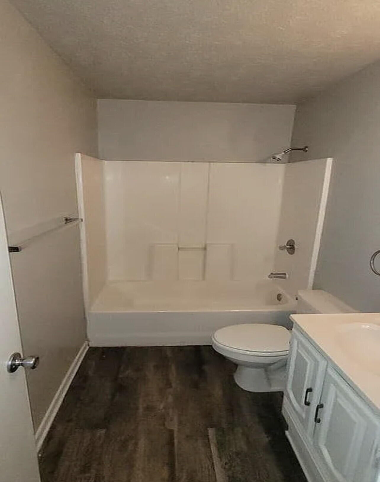 4427 31st Street, Unit A Lubbock, TX 79410 - Photo 6 of 9 a bathroom with a granite countertop toilet a sink and a bathtub