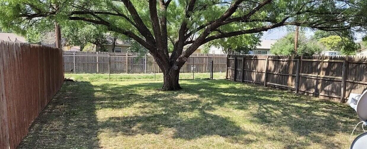 4427 31st Street, Unit A Lubbock, TX 79410 - Photo 8 of 9 a view of backyard with tree