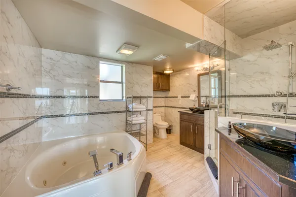 a large white kitchen with a large window