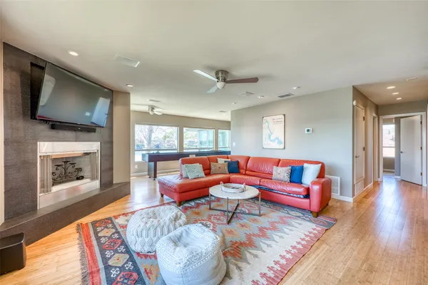 a living room with furniture a flat screen tv and a fireplace
