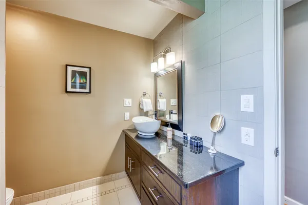 a bathroom with a sink a mirror and a toilet