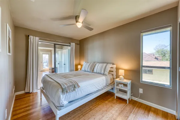 a bedroom with a large bed and a window