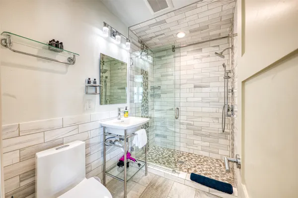 a bathroom with a sink toilet and shower