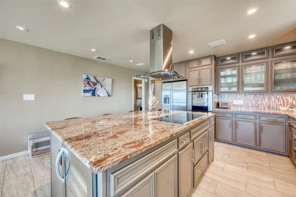 a kitchen with center island and stainless steel appliances