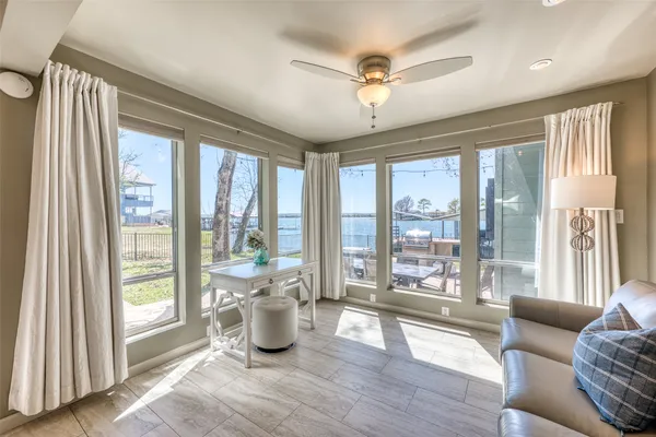 a living room with furniture and a large window with balcony view