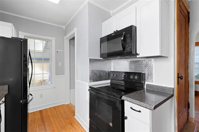 a kitchen with a stove and a microwave