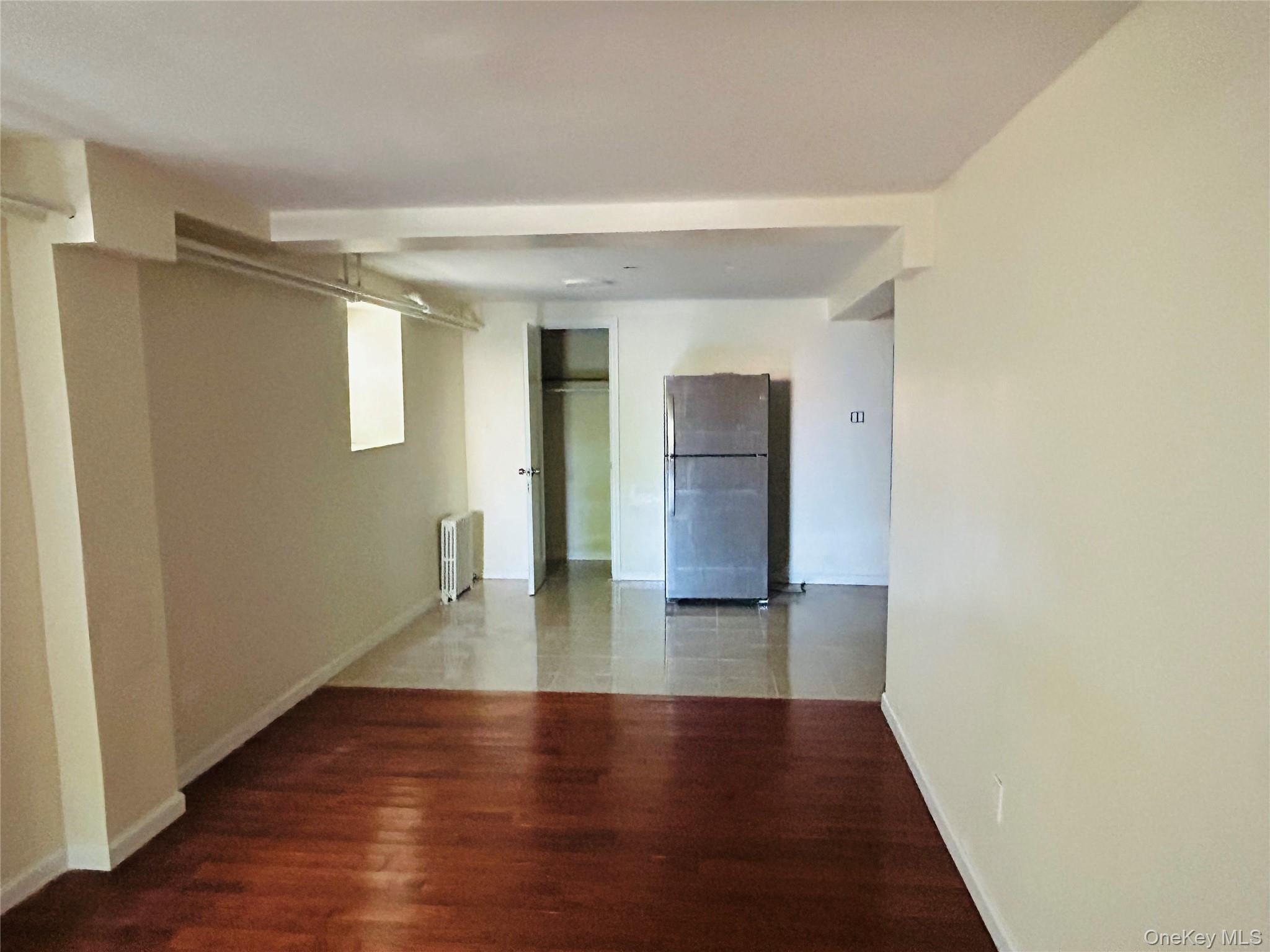 2910 Tenbroeck Avenue Bronx, NY 10469 - Photo 2 of 9 a view of empty room with wooden floor