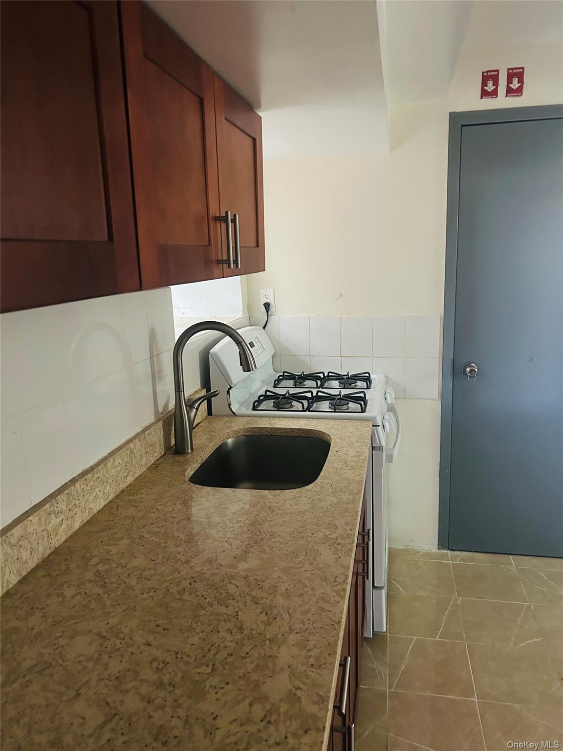 2910 Tenbroeck Avenue Bronx, NY 10469 - Photo 5 of 9 a close view of a sink and dishwasher a stove top oven with wooden floor