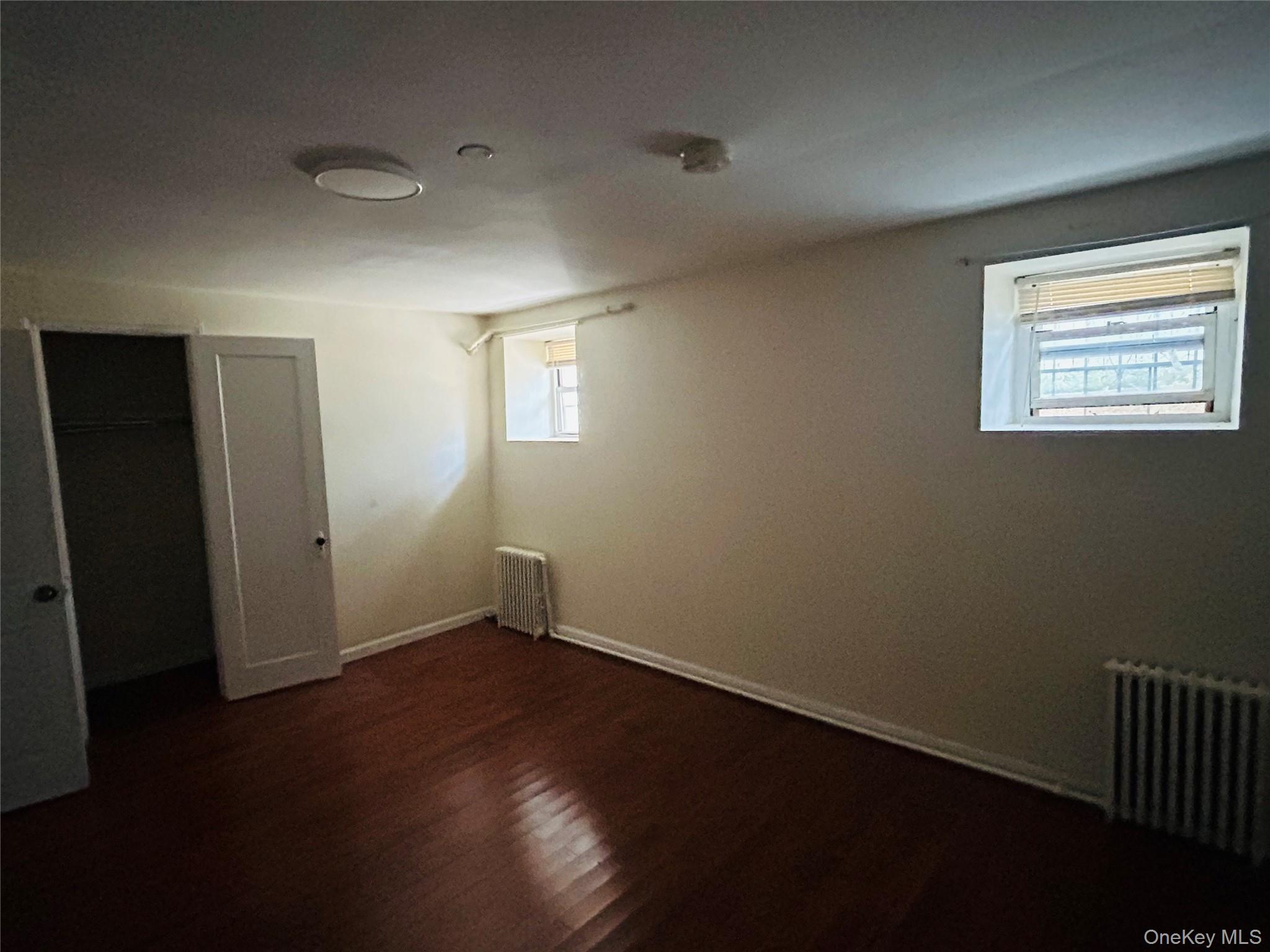 2910 Tenbroeck Avenue Bronx, NY 10469 - Photo 7 of 9 a view of an empty room with wooden floor and a window