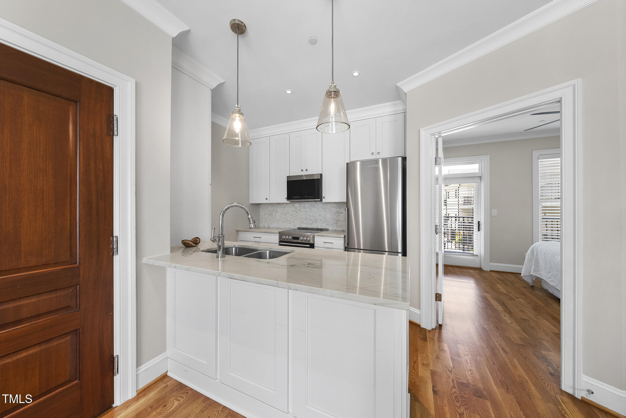606 Daniels Street, Unit B Raleigh, NC 27605 - Photo 14 of 27 a kitchen with a refrigerator a sink and wooden floor