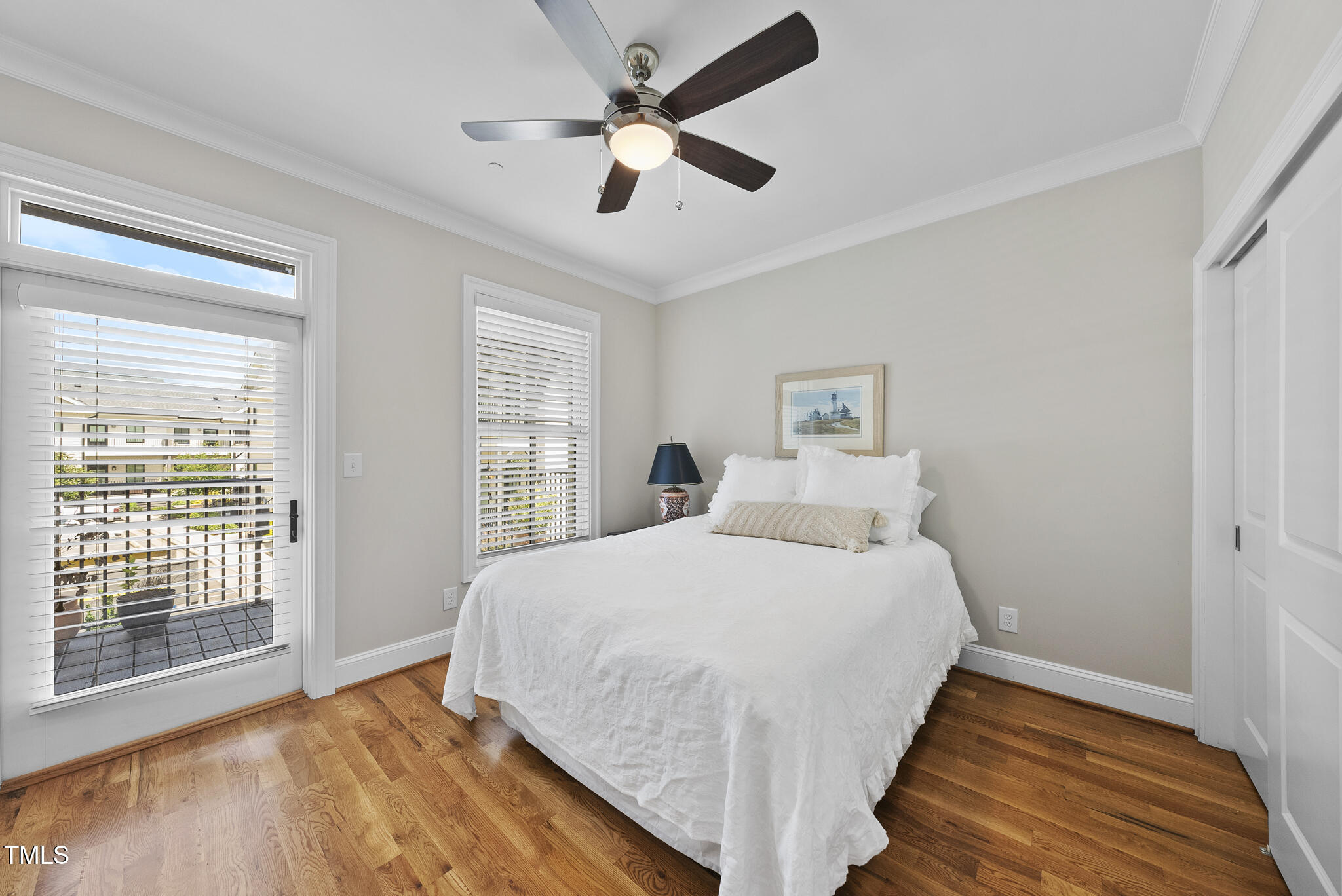 606 Daniels Street, Unit B Raleigh, NC 27605 - Photo 17 of 27 a bedroom with a large bed and a large window