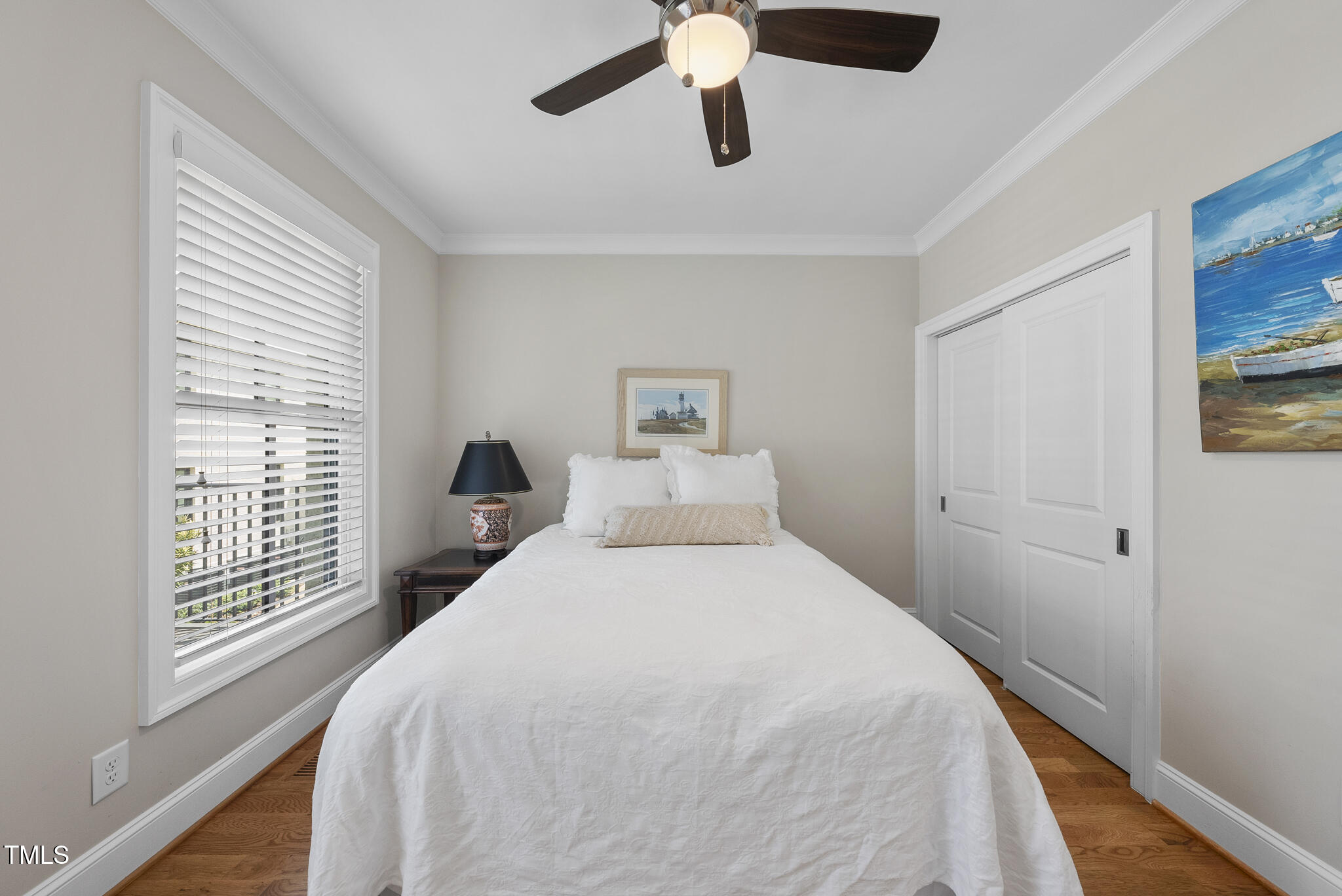 606 Daniels Street, Unit B Raleigh, NC 27605 - Photo 18 of 27 a bedroom with a large bed and a chandelier