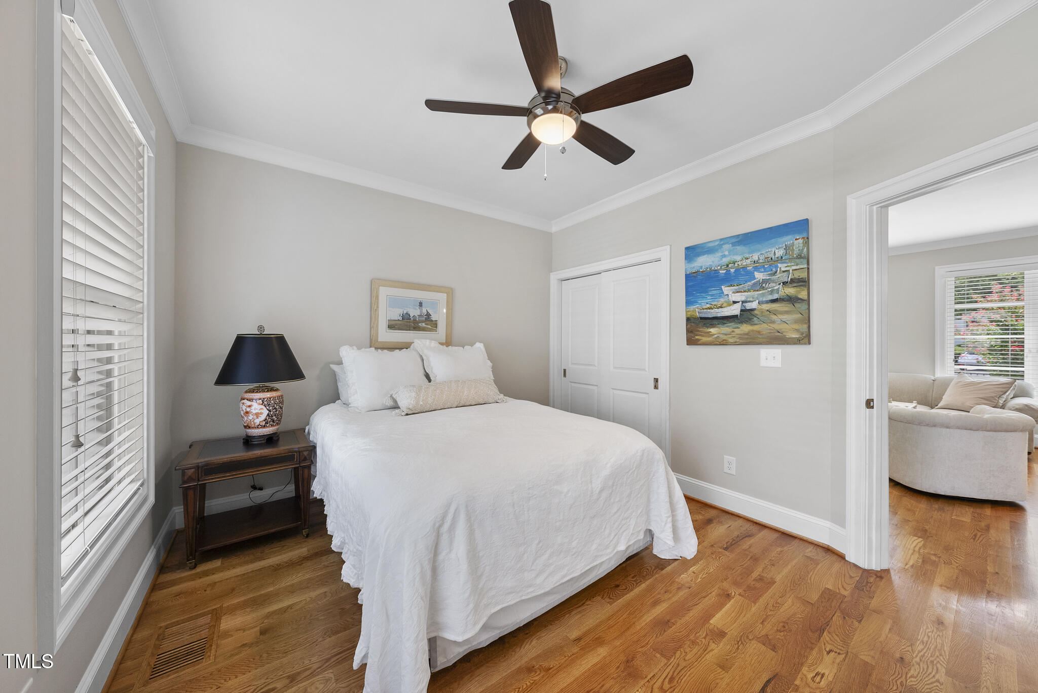 606 Daniels Street, Unit B Raleigh, NC 27605 - Photo 6 of 27 a bedroom with a bed and wooden floor