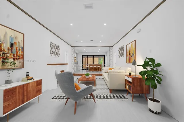 a living room with furniture and a potted plant