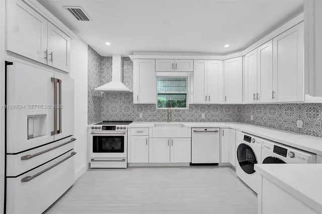 a kitchen with granite countertop white cabinets and white appliances