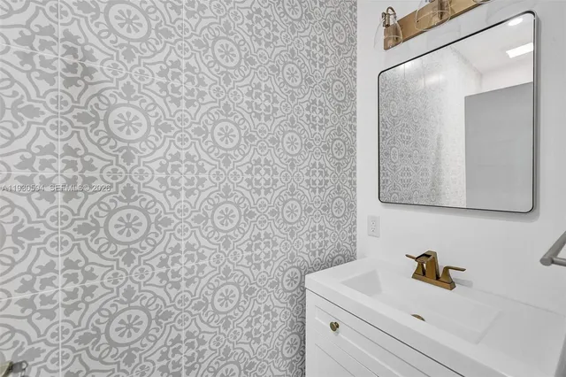 a bathroom with a sink and a mirror