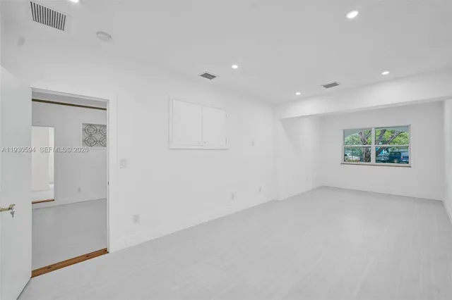 a front view of a house with a yard and tree