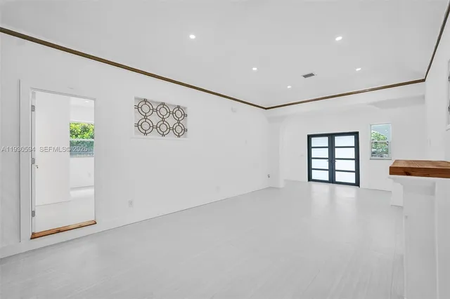 an empty room with windows and closet