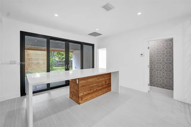 a spacious bedroom with a large bed and a large window