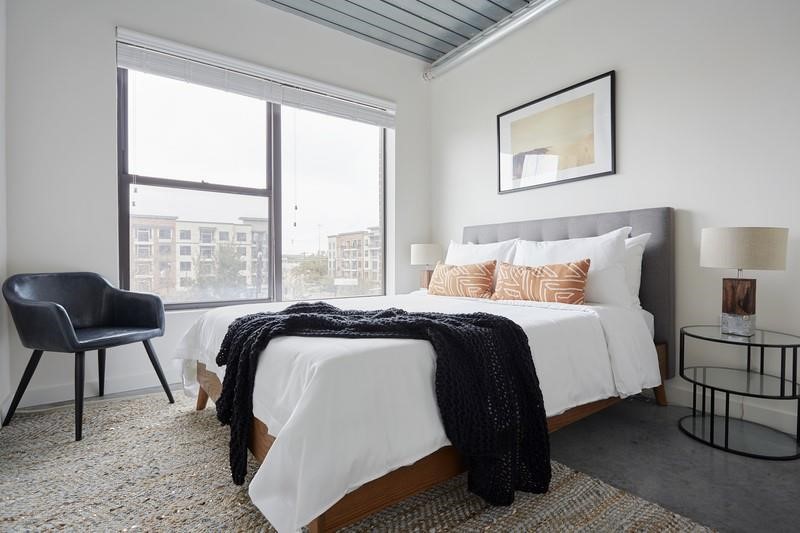 3550 Main Street, Unit 4416 Houston, TX 77002 - Photo 5 of 45 a bedroom with a bed and a large window