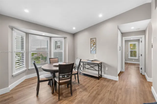 a view of a dining room with furniture window and wooden floor