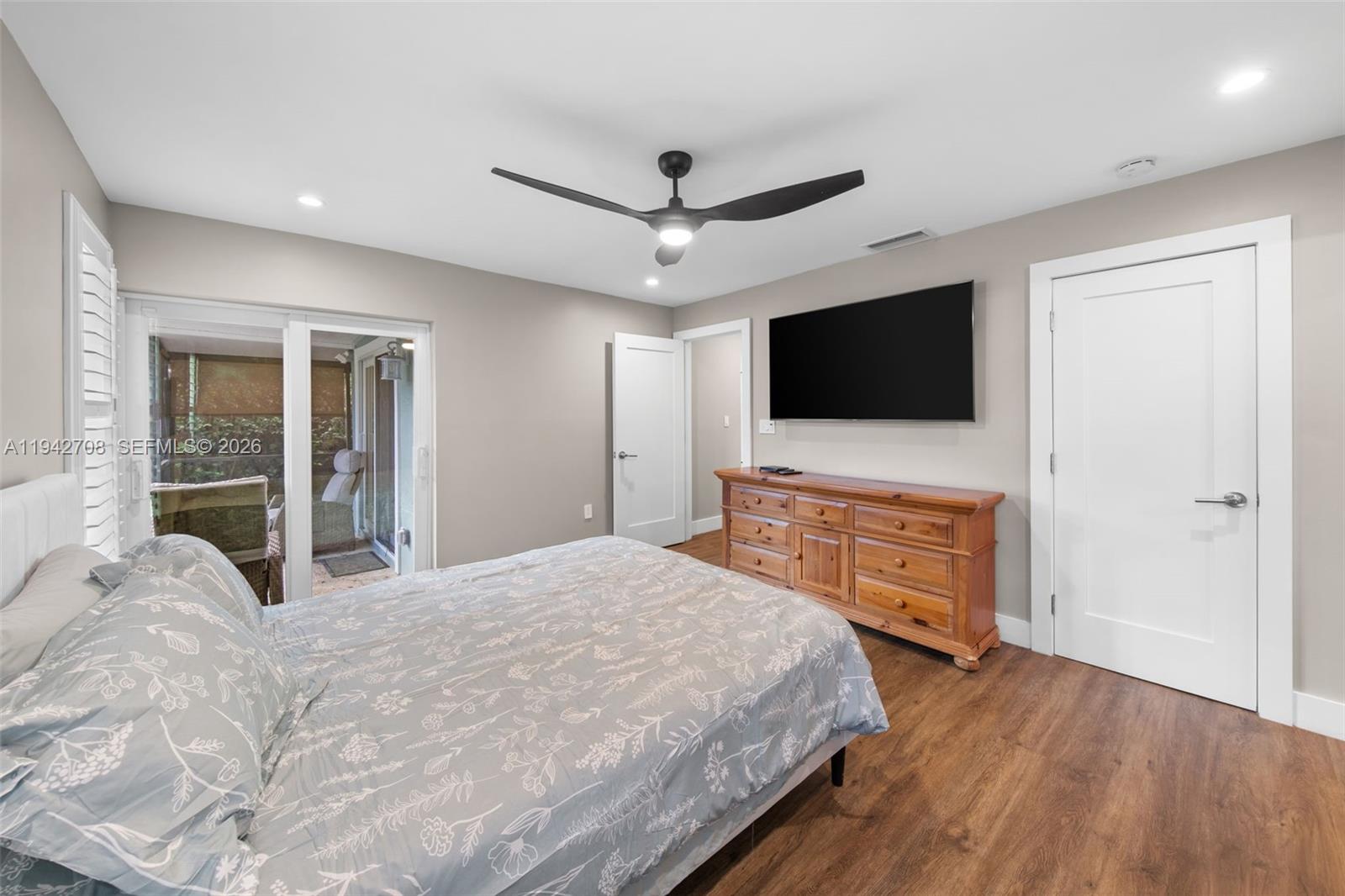 22239 Southwest 98th Place Cutler Bay, FL 33190 - Photo 16 of 67 a bedroom with a bed and a flat screen tv