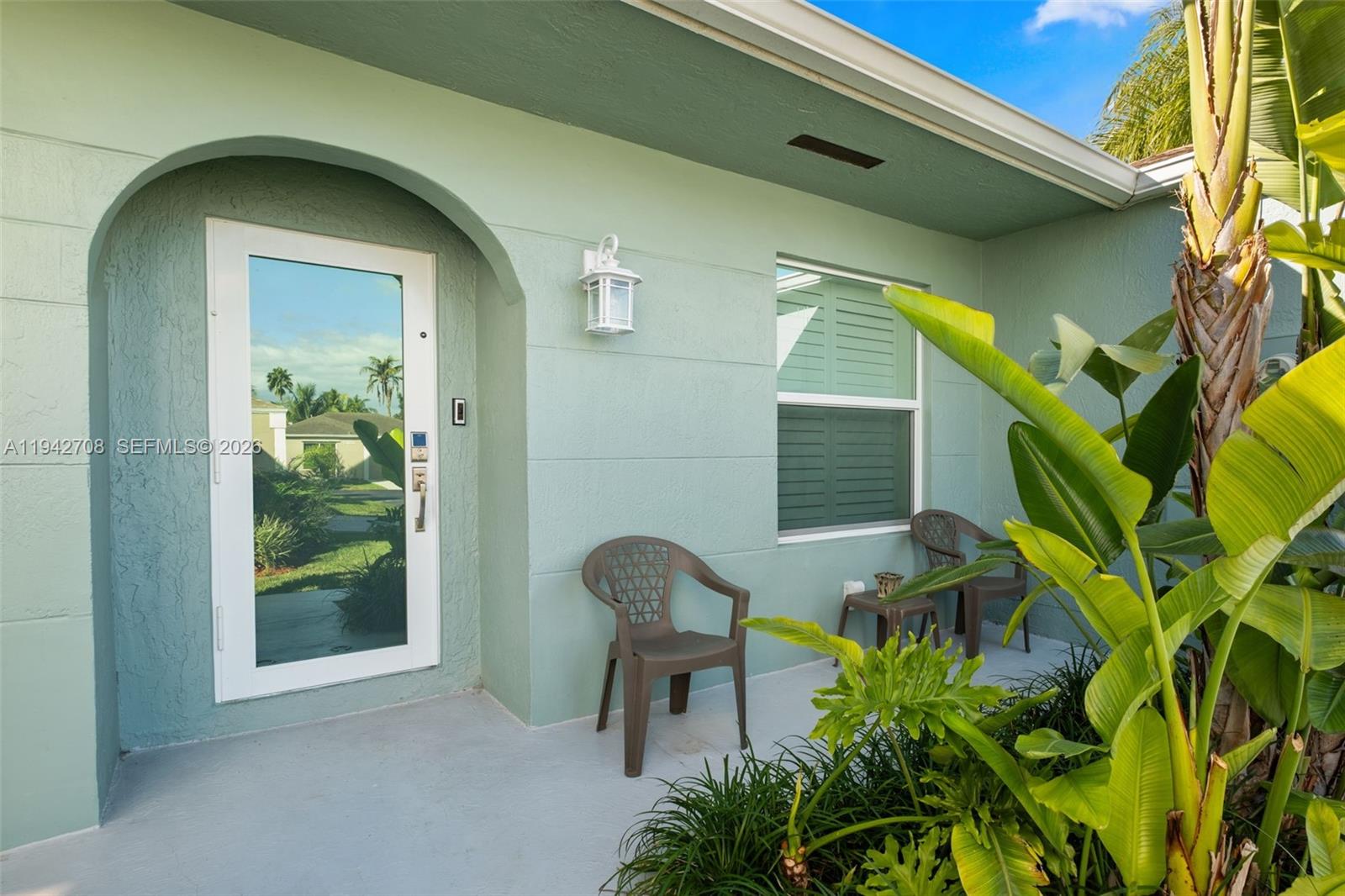 22239 Southwest 98th Place Cutler Bay, FL 33190 - Photo 26 of 67 a backyard of a house with table and chairs and potted plants